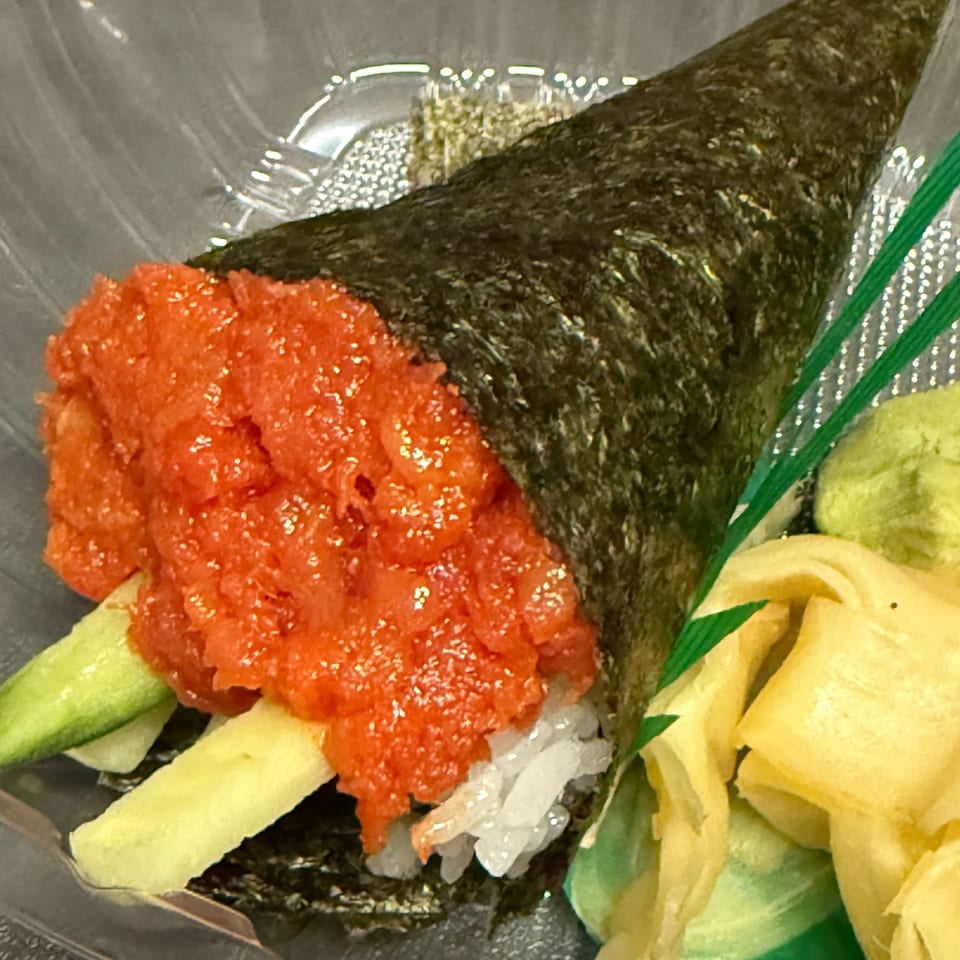 Koryo Sushi's spicy tuna hand roll with cucumber, rice, and seaweed, served with ginger and wasabi.